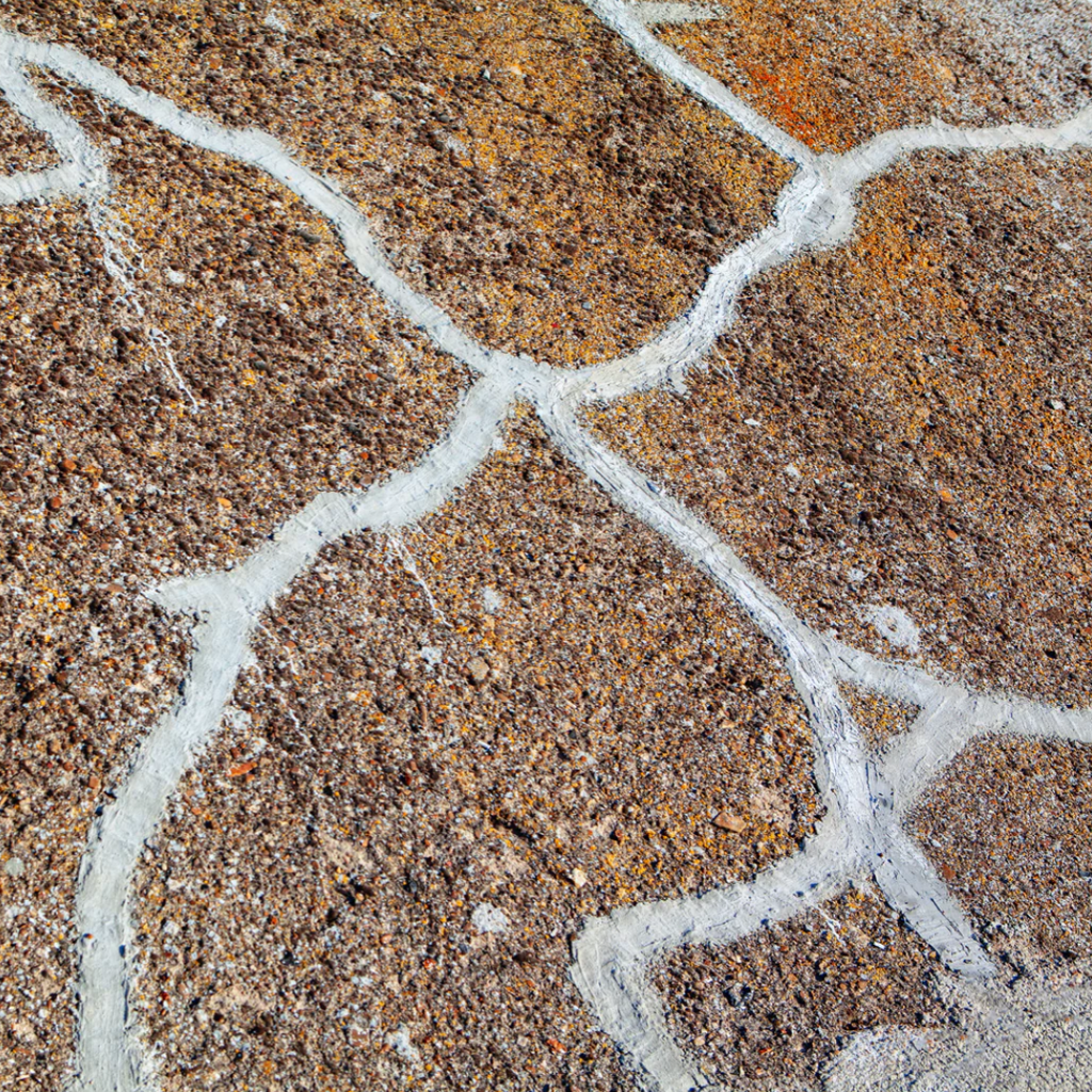 A cracked concrete surface that has been repaired using a concrete caulk.
