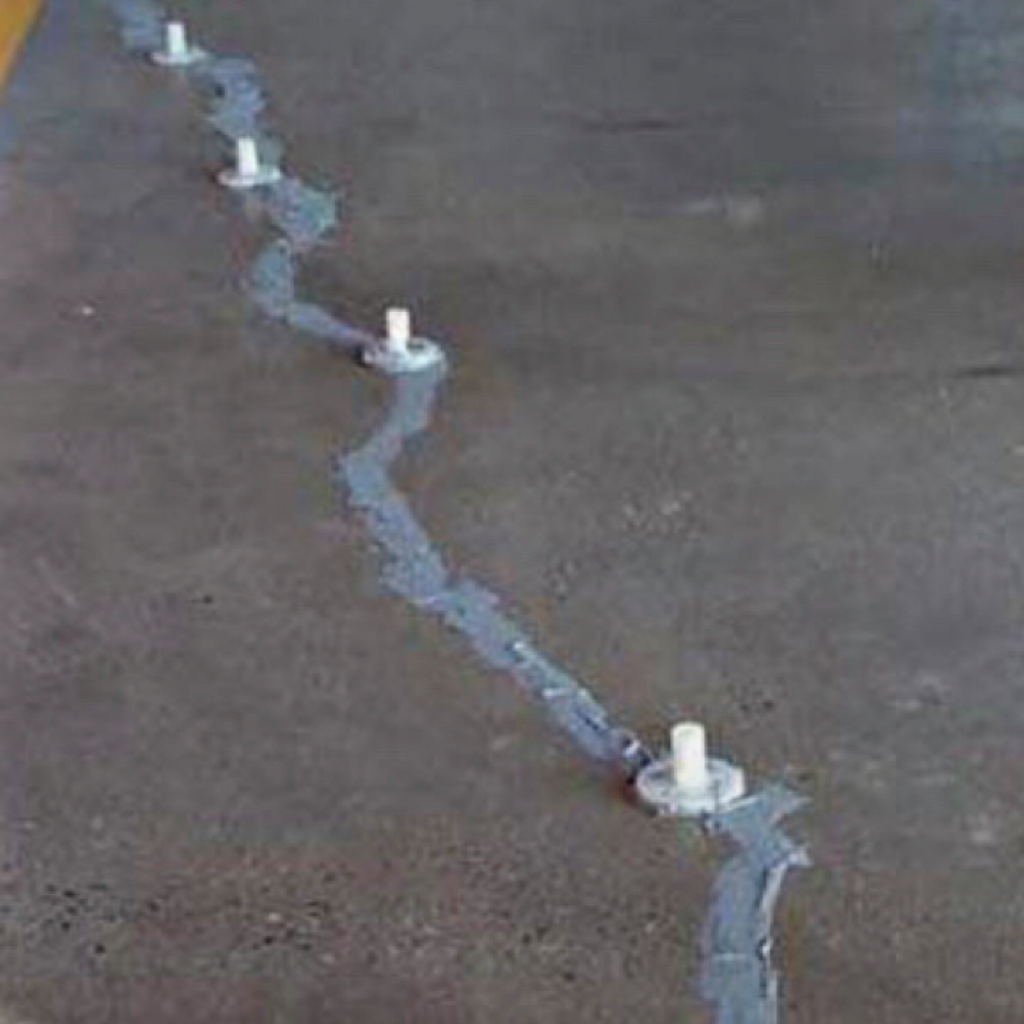 A concrete foundation crack that has been sealed and left to cure.
