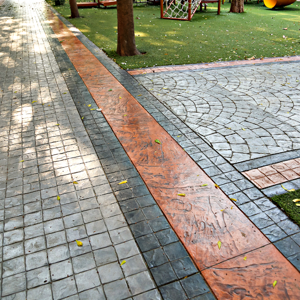 A stamped concrete patio that has been sealed to restore its color and create a shiny smooth surface.